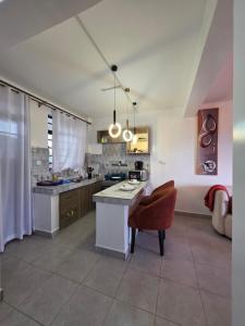 a large kitchen with a table and a chair at Rio Cabins in Nyeri +6 photos