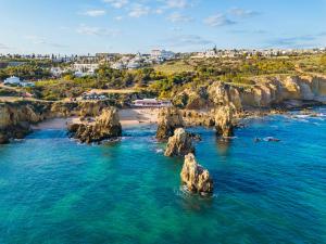 an aerial view of a beach with rocks in the water at Ocean Breeze Rooms, Albufeira in Albufeira