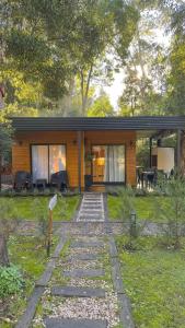 a small house with a walkway in front of it at Cabañas Sol de Abril in Mar del Plata