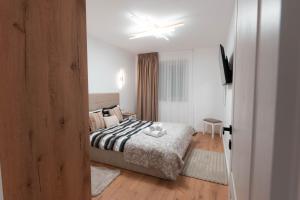 a bedroom with a bed and a ceiling fan at Luxury Residence in Baia Mare