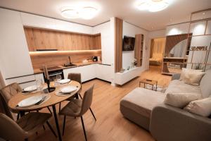 a living room with a table and a couch at Luxury Residence in Baia Mare