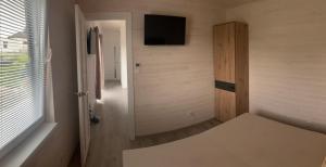 a room with a hallway with a tv on the wall at Domček in Budimír
