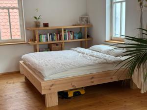 a bed in a room with a book shelf at Olive Garden in Groß-Bieberau