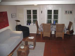 a living room with a couch and a table and chairs at Ferienhaus von der Ahe in Mohrkirch