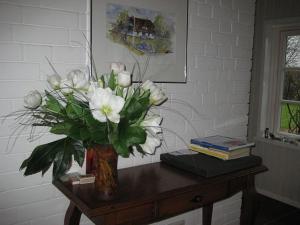 a vase of white flowers sitting on a table at Ferienhaus von der Ahe in Mohrkirch