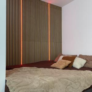 a bed in a bedroom with a large window at Love room - Montélimar in Montélimar