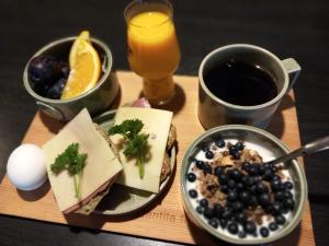 a wooden tray with a plate of food and a drink at Nature resort Linnunrata in Oulu