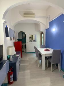 a dining room with a white table and chairs at Case di Ru in Finale Ligure