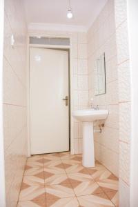 a bathroom with a sink and a white door at The π Homes in Eldoret +48 photos