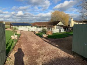 a shadow of a person standing on a driveway at fairfeilds cottage Frog Trotters Bottom in Hartpury