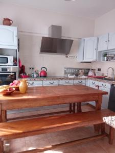 a kitchen with a wooden table in a kitchen at Chambre au panier in Marseille