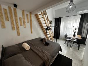a bedroom with a large bed and a staircase at ANA City Rooms in Cluj-Napoca