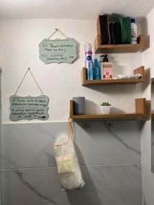 a bathroom with two wooden shelves on the wall at La Casetta di Nonno Mario in Chiusdino +25 photos