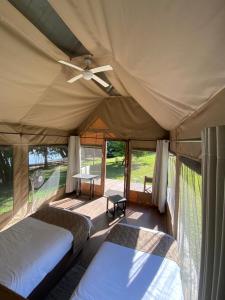 a tent with two beds and a table in it at Mongwe Safari Camp in Nyakarura +44 photos