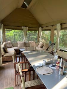 a living room with a table and a couch at Mongwe Safari Camp in Nyakarura