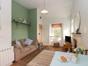 a living room with a couch and a table at Ardpatrick South Lodge in Tarbert