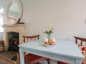 a table with a plate of bread and a mirror at Ardpatrick South Lodge in Tarbert