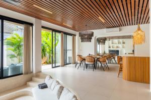 an open living room with a table and chairs at Unity Villa 1 Canggu in Canggu