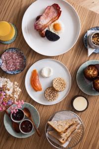 two plates of food on a wooden table at Tyddyn Llan Restaurant with Rooms in Corwen