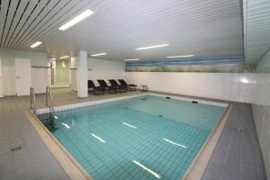 a large swimming pool in a building at Haus Norderhoog Wohnung 39 in Westerland
