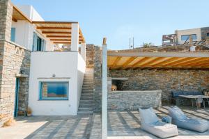 a patio with chairs and a brick building at Sunset Heaven Villa on Kea in Korissia +60 photos