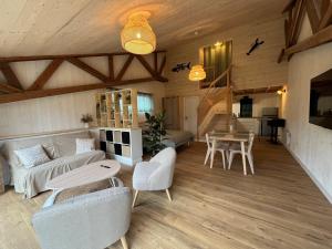 a living room with a couch and a table at ty loft keremma in Tréflez