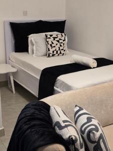 a person laying on a bed in a room at Bibo cabins in Ruringʼu