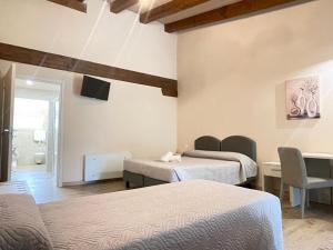 a hotel room with two beds and a television at Agriturismo Taglio del Re in Jesolo +86 photos