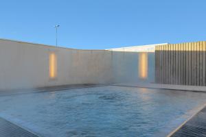 a swimming pool with water coming out of it at Hotel Vellir in Hafnarfjörður