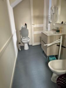 a bathroom with a toilet and a sink at Chez Elie in Saintes