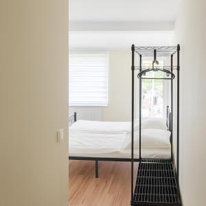 an iron bed with white sheets in a room at My Loft in Hagen