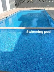 a large swimming pool with blue water at shankara stays in Bangalore