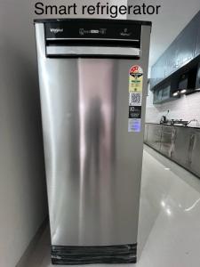 a stainless steel refrigerator sitting in a kitchen at shankara stays in Bangalore