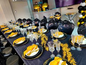 a long table with plates and wine glasses on it at Crown Palace Guesthouse in Pretoria