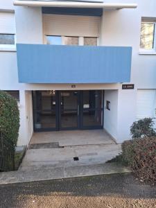 an entrance to a building with a blue awning at Charmant studio Thionville in Thionville