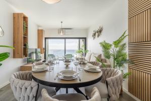a dining room with a table and chairs at Alma do mar luxury - Ocean front in Gaula