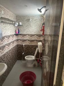 a bathroom with a toilet and a sink at The ARCS in Madurai