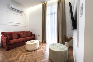 a living room with a couch and a table at Lithos Boutique Residences in Volos +75 photos