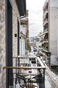 a view from a balcony of a street with buildings at Lithos Boutique Residences in Volos