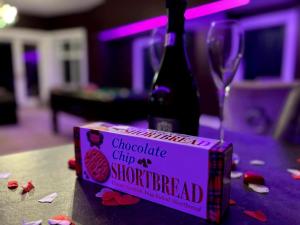 a box of choclate chip as sherbet and a bottle of wine at Hamilton Luxury - The James Suite in Scorton +72 photos