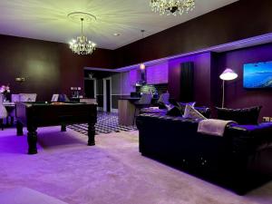 a living room with a pool table and purple walls at Hamilton Luxury - The James Suite in Scorton
