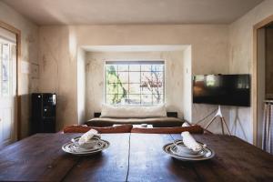 a room with a wooden table with two plates on it at Designer King Studio Private Curated Cottage in Cottonwood