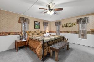 a bedroom with a bed and a ceiling fan at Prairie Creek Cabin Getaway in Rapid City