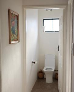 a bathroom with a toilet and a window at Huis Prins in Prince Albert +10 photos