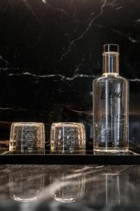 a bottle of water and glasses on a table at Blanq Gran vía in Valencia