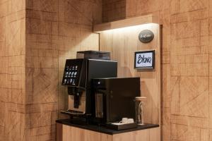a coffee machine on a shelf in a hotel room at Blanq Gran vía in Valencia