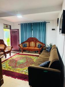 a living room with a bed and a rug at PINI ROO Villa in Badulla