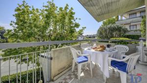 a patio with a table and chairs on a balcony at A casa di Attila DesenzanoLoft Official Partner Homes & Villas by Marriott Bonvoy in Desenzano del Garda +24 photos