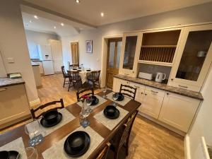 a kitchen and dining room with a table and chairs at 4, The Croft, Bellingham in Bellingham +8 photos