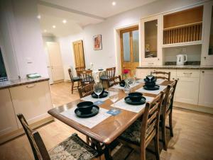 a dining room with a wooden table and chairs at 4, The Croft, Bellingham in Bellingham
